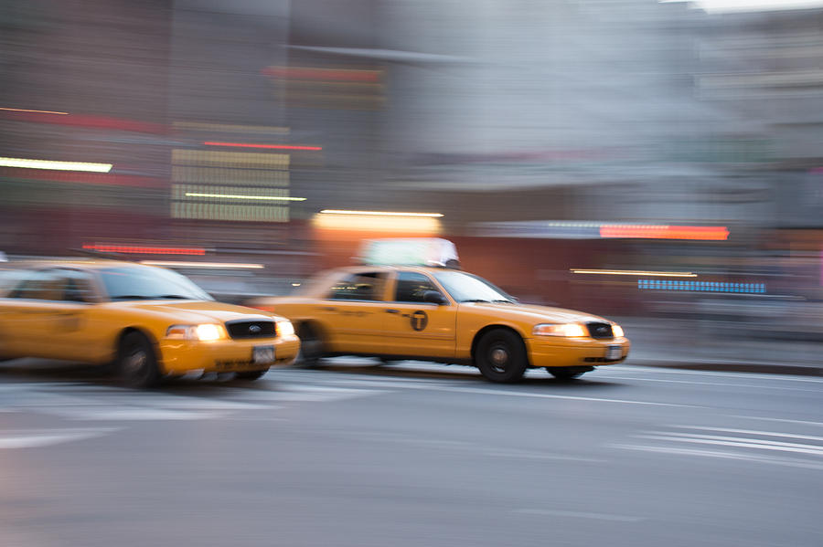 A taxi cab going at maximum speed.